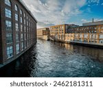 Industrial brick buildings along Tammerkoski rapids in Tampere, Finland