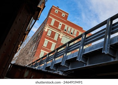 Industrial Bridge and Historic Red Brick Building, Low Angle View - Powered by Shutterstock