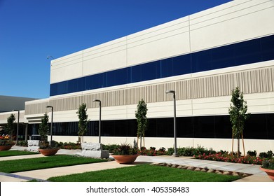 Industrial Building Exterior And Green Tree In Spring