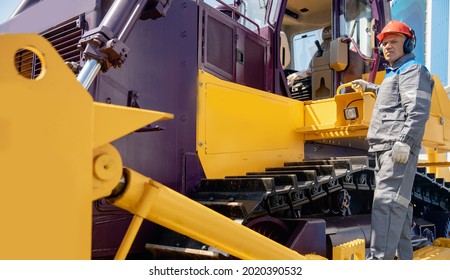 Industrial Bulldozer Driver Gets Into Coal Loading Cab In Open Pit Mine.