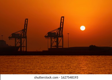 Industrial Cargo Port And Silhouette Of Cranes At Sunset Int Dubai, Jebel Ali, UAE