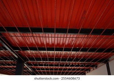 industrial ceiling with expose beam structure and colored with vibrance orange