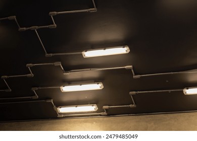 Industrial Ceiling Lights with Exposed Piping and Concrete Wall. Industrial Ceiling Lights with Exposed Piping and Concrete Wall. - Powered by Shutterstock