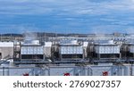 Industrial climate control infrastructure: An array of evaporative cooling towers managing the massive heat output of a data center part of the hyperscaling movement