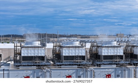Industrial climate control infrastructure: An array of evaporative cooling towers managing the massive heat output of a data center part of the hyperscaling movement