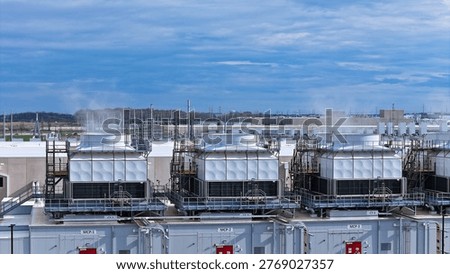 Industrial climate control infrastructure: An array of evaporative cooling towers managing the massive heat output of a data center part of the hyperscaling movement