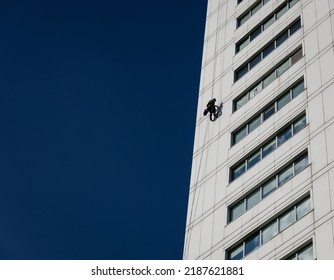 Industrial Climber In Helmet And Uniform On Height. Risky Job. Extreme Work. Worker Alpinist.