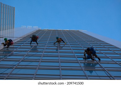 industrial climbers clean windows of high-rise buildings - Shutterstock ID 209741500