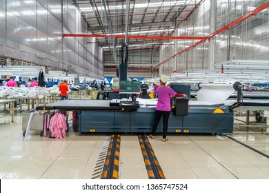 Industrial cloth cutting machine and fabric cutting area in garment factory in industrial zone in Ho Chi Minh City, Vietnam, with modern machinery and technology systems. - Powered by Shutterstock