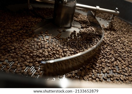 industrial coffee roasting machine mixer during operation full of roasted colombian coffee beans