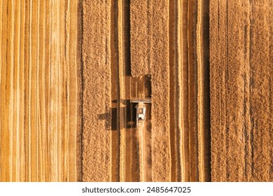 Industrial combine harvesters in agricultural field harvesting wheat. Location place Ukraine, Europe. Season of gathering crops. Agrarian industry. Aerial photography, drone shot. Beauty of earth. - Powered by Shutterstock