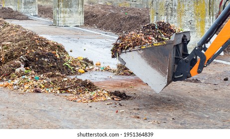 Industrial Compost Plant. Earth Mover Working With Pile Of Compost In Industrial Facility. Turning Organic Waste To Compost Soil.