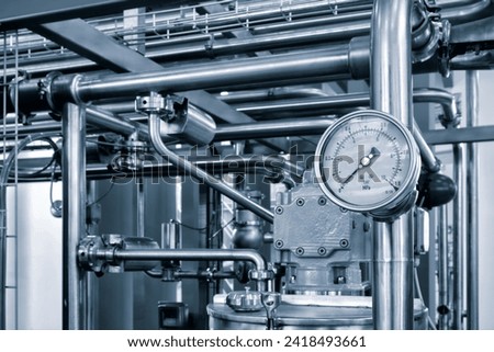 Industrial  concept. equipment of the boiler-house, - valves, tubes, pressure gauges, thermometer. Close up of manometer, pipe, flow meter, water pumps and valves of heating system in a boiler room.