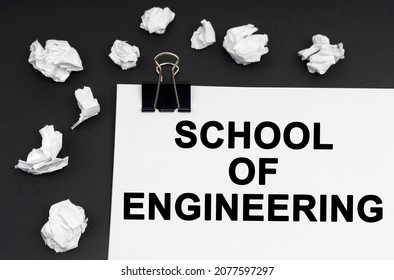 Industrial concept  On black background  there are crumpled pieces paper   paper and the inscription    School Of Engineering
