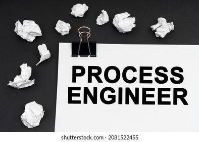 Industrial concept  On black background  there are crumpled pieces paper   paper and the inscription    Process Engineer