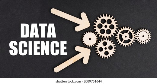 Industrial concept. On the black surface, arrows, gears and an inscription - DATA SCIENCE