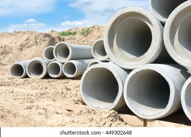 Industrial Concrete Drainage Pipes Stacked For Construction. New Tubes