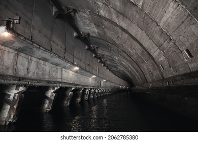 Industrial concrete tunnel interior perspective, part of abandoned underground submarine base from USSR period. Balaklava, Crimea