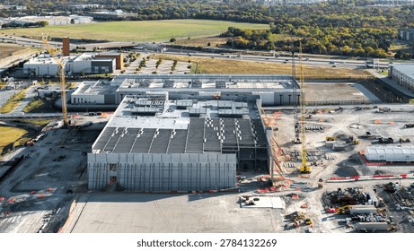 Industrial construction site with cranes developing a large data center structure