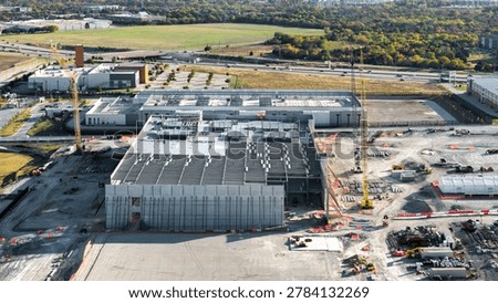 Industrial construction site with cranes developing a large data center structure