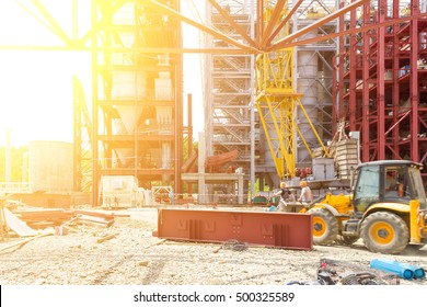 Industrial Construction. Workers Assemblers On The Excavator On The Construction Of An Industrial Facility. Tinted Image. Selective Focus