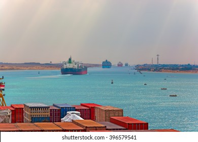 Industrial Container Ship Passing Through Suez Canal With Ship's Convoy, View On The Bow From The Captain Bridge.