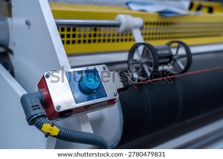 Industrial control button and rotary encoder on manufacturing machine