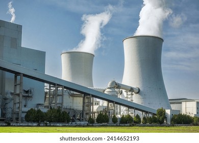 Industrial Cooling Towers Emitting Steam at Power Plant