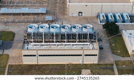 Industrial Data center facility with multiple cooling towers and HVAC equipment on a commercial rooftop