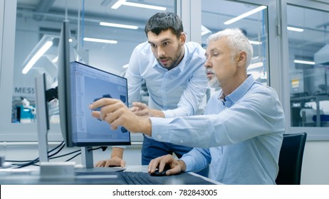 Industrial Designer Has Conversation with Senior Engineer While Working in CAD Program, Designing New Component. He Works on Personal Computer with Two Monitors.