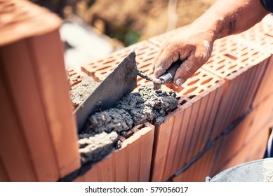 Industrial Details - Construction Bricklayer Worker Building Walls With Bricks, Mortar And Putty Knife
