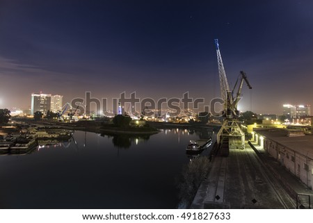 Similar – Pastel evening atmosphere at the harbor basin with cargo cranes