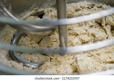 Industrial Dough Mixer Kneads The Dough. Raw Dough In A Industrial Bakery Dough Mixer, Food Concept. Close-up