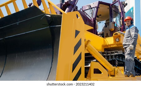 Industrial Driver Of Yellow Bulldozer Gets Into Coal Loading Cab In Open Pit Mine.