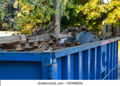 Industrial dumpster filled Loaded dumpster near a construction site, home renovation
