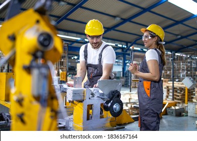 Industrial Employees Working Together In Factory Production Line.