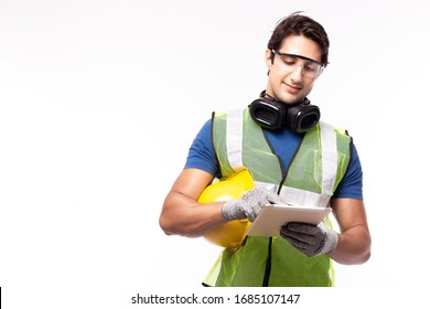 Industrial Engineer Guy Hold Hard Hat Wearing Safety Jacket, Safety Eyeglasses, Using Touchscreen Tablet Computer. Worker Young Man Work At Industry Manufacturing Factory. Copy Space, White Background