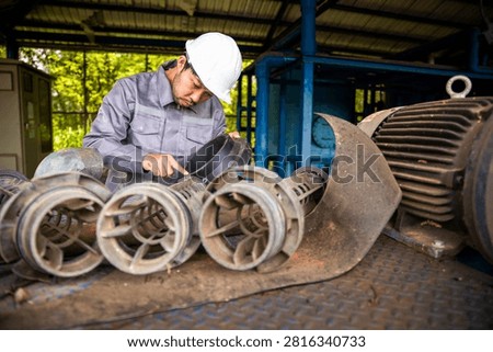 Industrial Engineer Inspecting Mechanical Pump Components for Preventive Maintenance Program