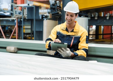 Industrial engineer manager or industrial engineer manager using ipad digital table checking quality metal at industry and checking production process at manufacturing factory - Powered by Shutterstock