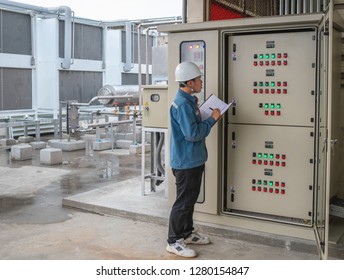 Industrial engineer monitoring check system of temperature refrigeration and status electrical circuit on board panel of cold storage room  in the factory