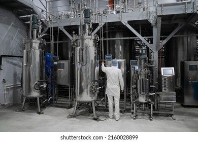 Industrial Engineer Standing In Front Of A Chemical Plant, Producing Organic Fertilizers. Industrial Worker Controlling Production And Checking Quality