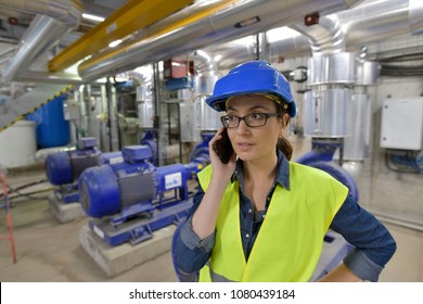 Industrial engineer talking on phone in recyling plant