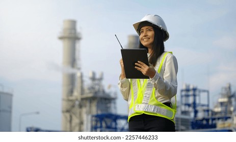 Industrial engineer using digital tablet for work against the electrical plant - Powered by Shutterstock