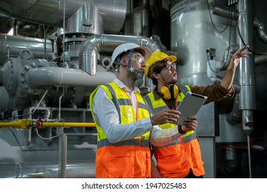 Industrial engineer with worker discussing project at large industry factory,Teamwork. - Powered by Shutterstock