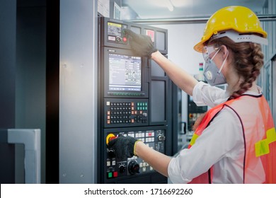 Industrial Engineer Worker Female Wearing Helmet, Safe Glasses And Mask, Pointing And Touching Instrument Panel Buttons At Manufacturing Plant Factory, Young Beautiful Woman Working In Industry