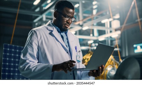 Industrial Engineer Working On Artificial Satellite Construction. Aerospace Agency: African American Scientist Using Laptop Computer To Develop Spacecraft For Space Exploration And Data Communication.