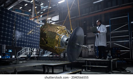 Industrial Engineer Working On Artificial Satellite Construction. Aerospace Agency: Scientist Using Laptop Computer To Develop Spacecraft For Space Exploration And Data Communication.