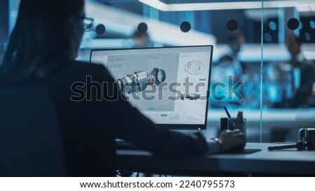 Industrial Engineer Working on CAD Software on Desktop Computer in Turbine Engine Startup Facility. Specialists and Professionals Researching and Developing High Tech Engine Technology.