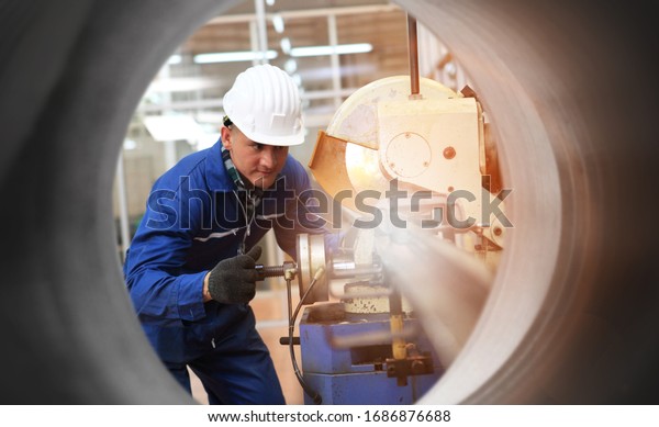  Industrial Engineers in Hard Hats  with  machine.\
Assist production engineer in industry. He checking or push\
metalwork control in industrial In a plastic factory for car.\
Concept Successful Of Work.