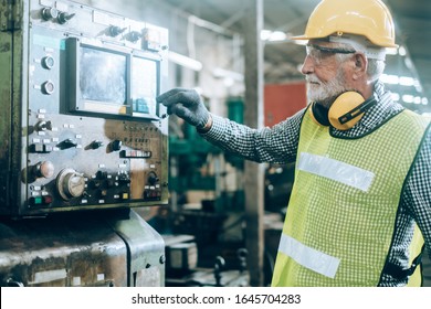 Industrial Engineers in Hard Hats.Work at the Heavy Industry Manufacturing Factory.industrial worker indoors in factory.aged man working in an industrial factory. - Powered by Shutterstock